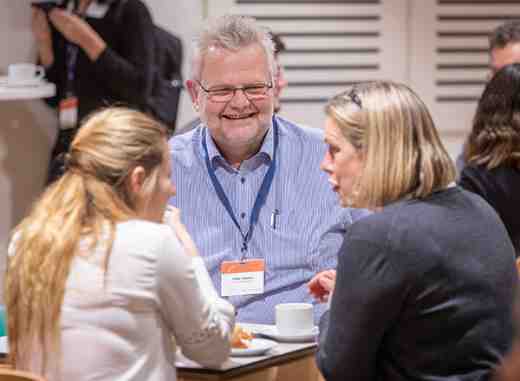 Delegates chatting at a meeting