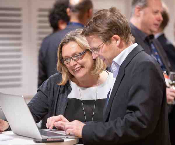 People chatting at a meeting